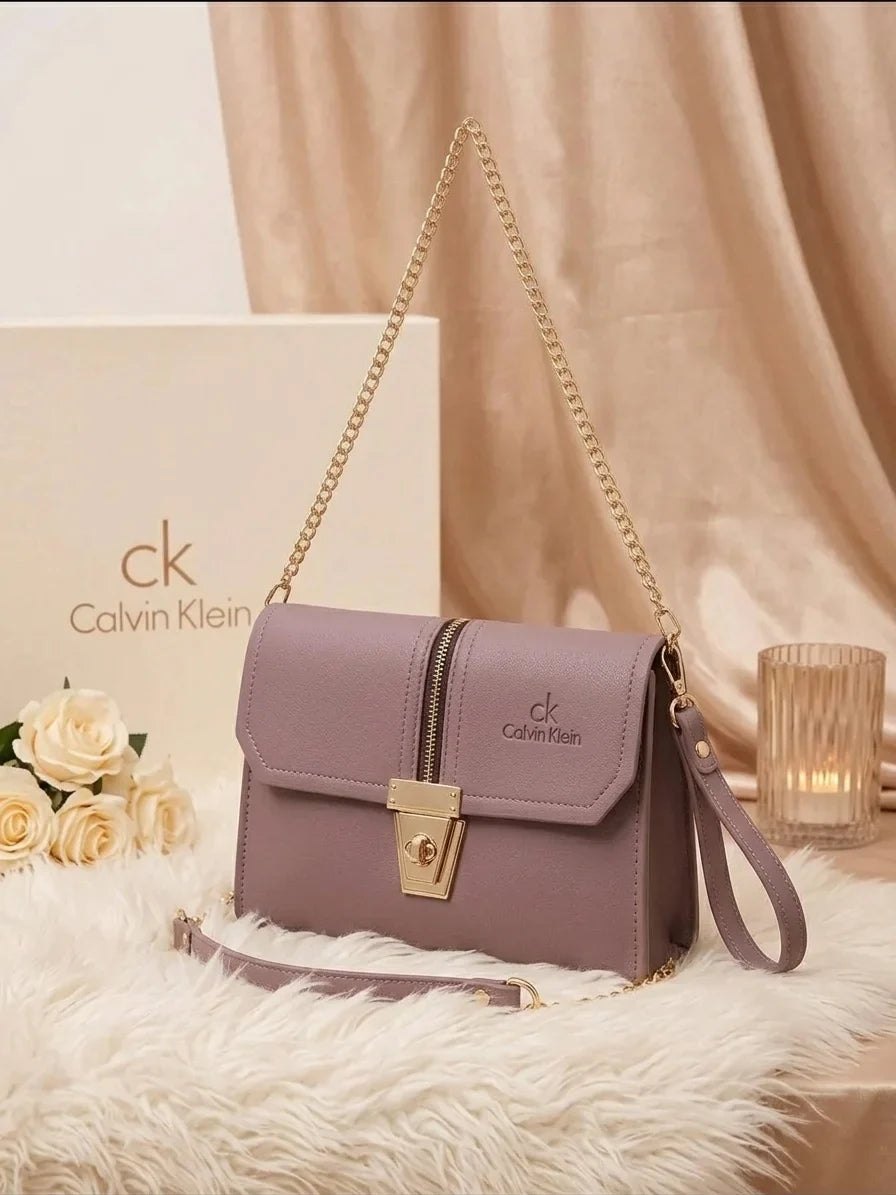Crossbody bag with adjustable gold chain and wristlet